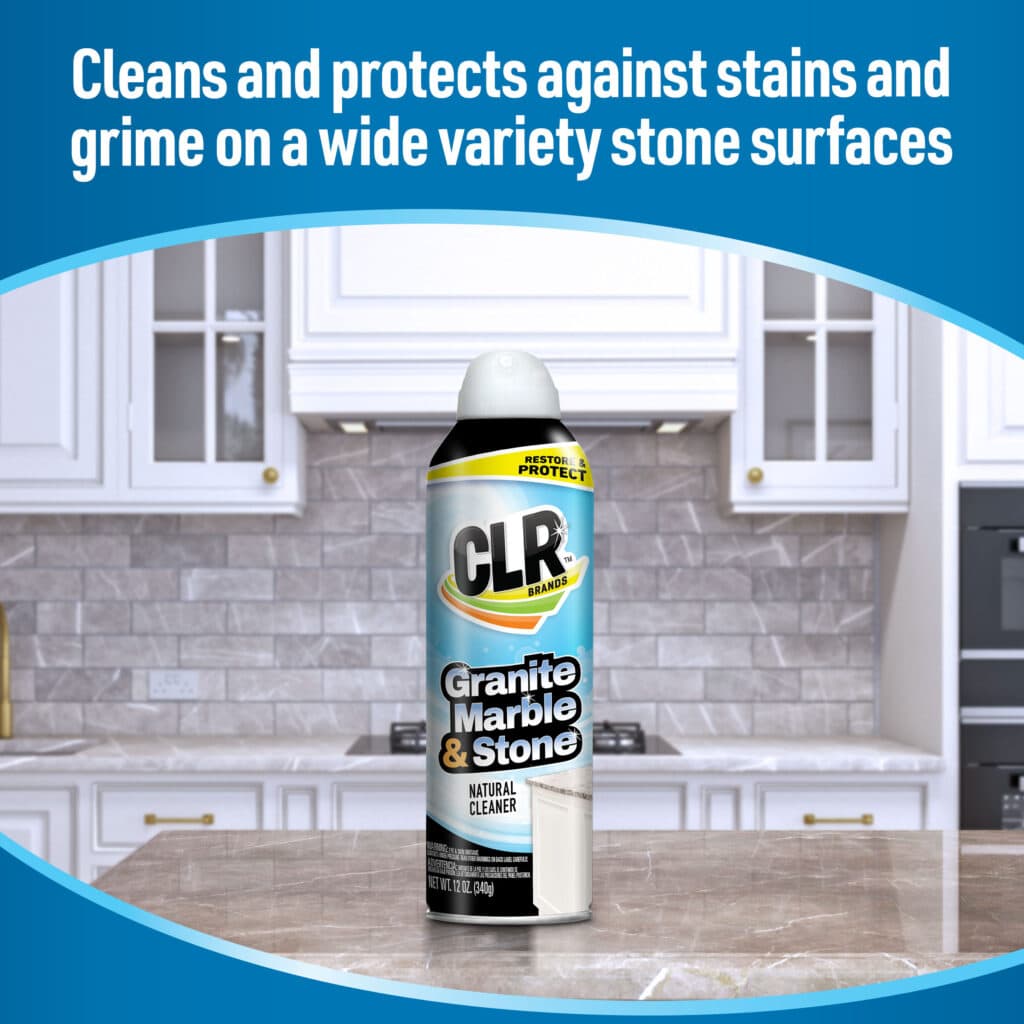 CLR Granite Marble & Stone cleaner can on a kitchen counter with white cabinets and tiled backsplash.