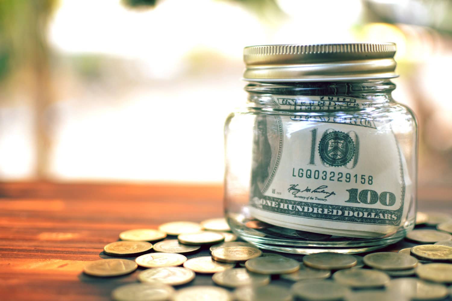 Coin jar with cash contained inside of it.