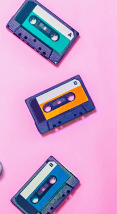 Three colorful cassette tapes labeled A and B arranged diagonally on a pink background.