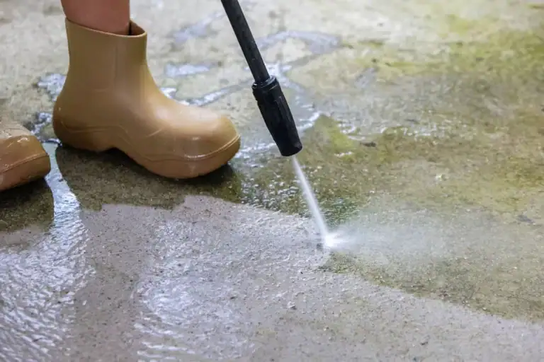 Woman,Cleaning,Concrete,Pavement,Using,High,Pressure,Washer.